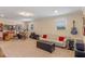 Large recreation room featuring carpet flooring, a white couch, and instruments in the background at 4232 Spring Ln, Lakeland, FL 33811