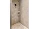 Tiled shower stall featuring a shower head and built-in shelves at 4232 Spring Ln, Lakeland, FL 33811
