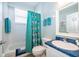 Bright bathroom with a shower-tub combo, white vanity, and a playful Disney themed shower curtain at 428 Orista Dr, Davenport, FL 33897