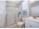 Clean bathroom featuring a glass-enclosed shower, white fixtures, and a bright, airy feel at 428 Orista Dr, Davenport, FL 33897