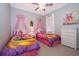 Adorable bedroom with two twin beds, princess-themed decor, and soft, colorful accents at 428 Orista Dr, Davenport, FL 33897