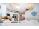Open-concept kitchen with stainless steel appliances, white cabinets, quartz countertops, and eat-in dining area at 428 Orista Dr, Davenport, FL 33897