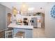 Well-lit kitchen featuring stainless steel appliances, breakfast bar with seating, and stylish pendant lighting at 428 Orista Dr, Davenport, FL 33897