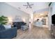 Open living room showcasing wood-look floors, stylish furnishings, and seamless flow into the adjacent kitchen area at 428 Orista Dr, Davenport, FL 33897