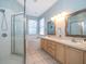 Spacious main bathroom with a soaking tub, dual vanities, and walk-in shower at 428 Orista Dr, Davenport, FL 33897