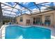 Inviting swimming pool with covered patio, ideal for outdoor entertaining and leisure at 428 Orista Dr, Davenport, FL 33897
