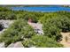 Aerial view shows condos are surrounded by lush green trees near a lake at 4340 S Kirkman Rd # 901, Orlando, FL 32811