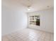 Bright, tiled bedroom featuring a large window with natural light and a ceiling fan at 4340 S Kirkman Rd # 901, Orlando, FL 32811