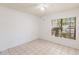 Bright bedroom with tile floors, a ceiling fan, and a sunlit window at 4340 S Kirkman Rd # 901, Orlando, FL 32811