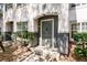 Close-up view of a well-maintained condo front door with a stylish paint, modern hardware, and neat landscaping at 4340 S Kirkman Rd # 901, Orlando, FL 32811