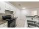 The kitchen has white cabinets, tile backsplash, granite countertops, and modern appliances at 4340 S Kirkman Rd # 901, Orlando, FL 32811