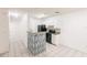 Efficient kitchen featuring white cabinets, modern black appliances, breakfast bar, and easy access to living area at 4340 S Kirkman Rd # 901, Orlando, FL 32811