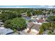 Aerial view of a residential neighborhood featuring various homes, lush greenery, and clear blue skies at 50989 Highway 27 # 174, Davenport, FL 33897