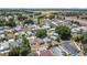 An aerial view shows many homes nestled within a community with trees at 50989 Highway 27 # 174, Davenport, FL 33897