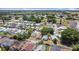Aerial view shows homes nestled within a community filled with trees and community pools at 50989 Highway 27 # 174, Davenport, FL 33897