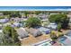 An aerial view shows many homes nestled within a community filled with trees and a glimpse of community pools at 50989 Highway 27 # 174, Davenport, FL 33897