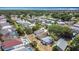 An aerial view shows homes nestled within a community filled with trees and community pools at 50989 Highway 27 # 174, Davenport, FL 33897