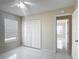 Bright bedroom featuring white tile floor, a double door closet, and a window at 50989 Highway 27 # 174, Davenport, FL 33897