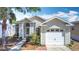 Charming single-story home featuring a one-car garage and well-maintained landscaping at 50989 Highway 27 # 174, Davenport, FL 33897