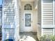 Close-up of a white front door with decorative windows and side panels at 50989 Highway 27 # 174, Davenport, FL 33897
