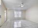 Open living room with high ceilings, white tile flooring, and natural light at 50989 Highway 27 # 174, Davenport, FL 33897