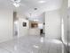Spacious living room featuring tile floors, ceiling fan, and view to kitchen at 50989 Highway 27 # 174, Davenport, FL 33897