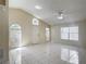 Spacious living room with vaulted ceilings, white tile flooring, and lots of natural light at 50989 Highway 27 # 174, Davenport, FL 33897