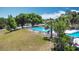 Aerial view of a community pool surrounded by lush landscaping at 50989 Highway 27 # 174, Davenport, FL 33897