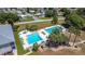 Aerial view of two community pools and jacuzzi with palm trees and lounge chairs, surrounded by homes at 50989 Highway 27 # 174, Davenport, FL 33897