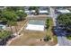 Aerial view of shuffleboard court in a sunny residential community with mature trees and well-maintained landscapes at 50989 Highway 27 # 174, Davenport, FL 33897