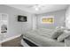 Light-filled bedroom showcasing a flat screen tv and wood-look floors at 5809 Willow Bud Ct, Orlando, FL 32807