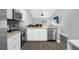 Well-lit kitchen with stainless steel appliances, opening into an adjacent living area at 5809 Willow Bud Ct, Orlando, FL 32807