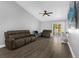 Comfortable living room with stylish seating, vinyl floors, and sliding glass doors to the backyard at 5809 Willow Bud Ct, Orlando, FL 32807