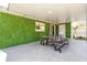 Covered patio with a green wall, tile flooring, and dining table at 5809 Willow Bud Ct, Orlando, FL 32807