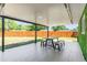 Covered patio with tile flooring and a dining table at 5809 Willow Bud Ct, Orlando, FL 32807