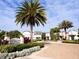 The Enclaves Amenity Center entrance with brick road, lush landscaping and well maintained buildings at 646 Longboat Dr, Davenport, FL 33896