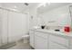 A well-lit bathroom featuring a shower with curtain and white vanity with cartoon decor at 646 Longboat Dr, Davenport, FL 33896
