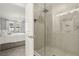 Modern bathroom featuring a glass-enclosed shower and neutral-toned tile, complemented by a spacious bedroom at 646 Longboat Dr, Davenport, FL 33896
