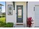Inviting front entrance with stylish door, modern fixtures, and tidy landscaping at 646 Longboat Dr, Davenport, FL 33896