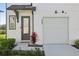 Inviting front entrance with stylish door, modern fixtures, and tidy landscaping at 646 Longboat Dr, Davenport, FL 33896