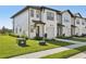 Townhouse featuring a well-maintained lawn and private walkway leading to the front door, enhancing curb appeal at 646 Longboat Dr, Davenport, FL 33896