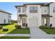 Charming townhouse with a well-maintained lawn, a private garage and walkway leading to the front door at 646 Longboat Dr, Davenport, FL 33896