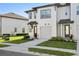 Charming townhouse with a well-maintained lawn, a private garage and walkway leading to the front door at 646 Longboat Dr, Davenport, FL 33896