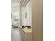 Modern hallway featuring stylish decor, wood accent paneling, and a view into the living area at 646 Longboat Dr, Davenport, FL 33896