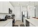 Modern kitchen with white cabinets, stainless steel appliances, ample counter space, and sleek design at 646 Longboat Dr, Davenport, FL 33896