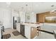 Bright kitchen featuring stainless steel appliances, a center island with seating, and open access to the living area at 646 Longboat Dr, Davenport, FL 33896