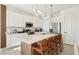 Well-equipped kitchen with white cabinets, stainless steel appliances, and an island with barstool seating at 646 Longboat Dr, Davenport, FL 33896