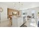 Open concept kitchen features an island with seating that looks into the living and dining areas, great for entertaining at 646 Longboat Dr, Davenport, FL 33896