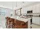 Modern kitchen with white cabinets, stainless steel appliances, a large island with seating, and pendant lighting at 646 Longboat Dr, Davenport, FL 33896