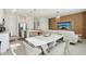 Open-concept living area with modern kitchen, stainless steel appliances, and stylish dining and seating areas at 646 Longboat Dr, Davenport, FL 33896